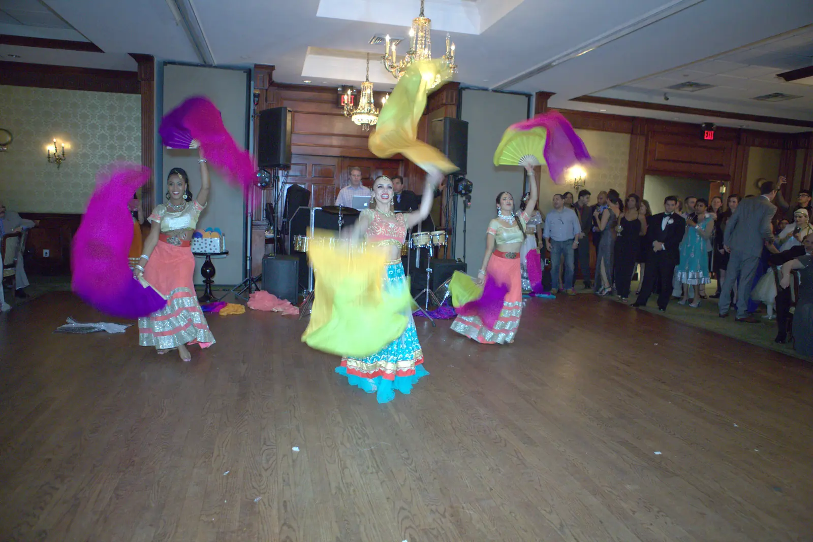 Bollywood dancers performing with colorful silk veils on the dance floor at a party