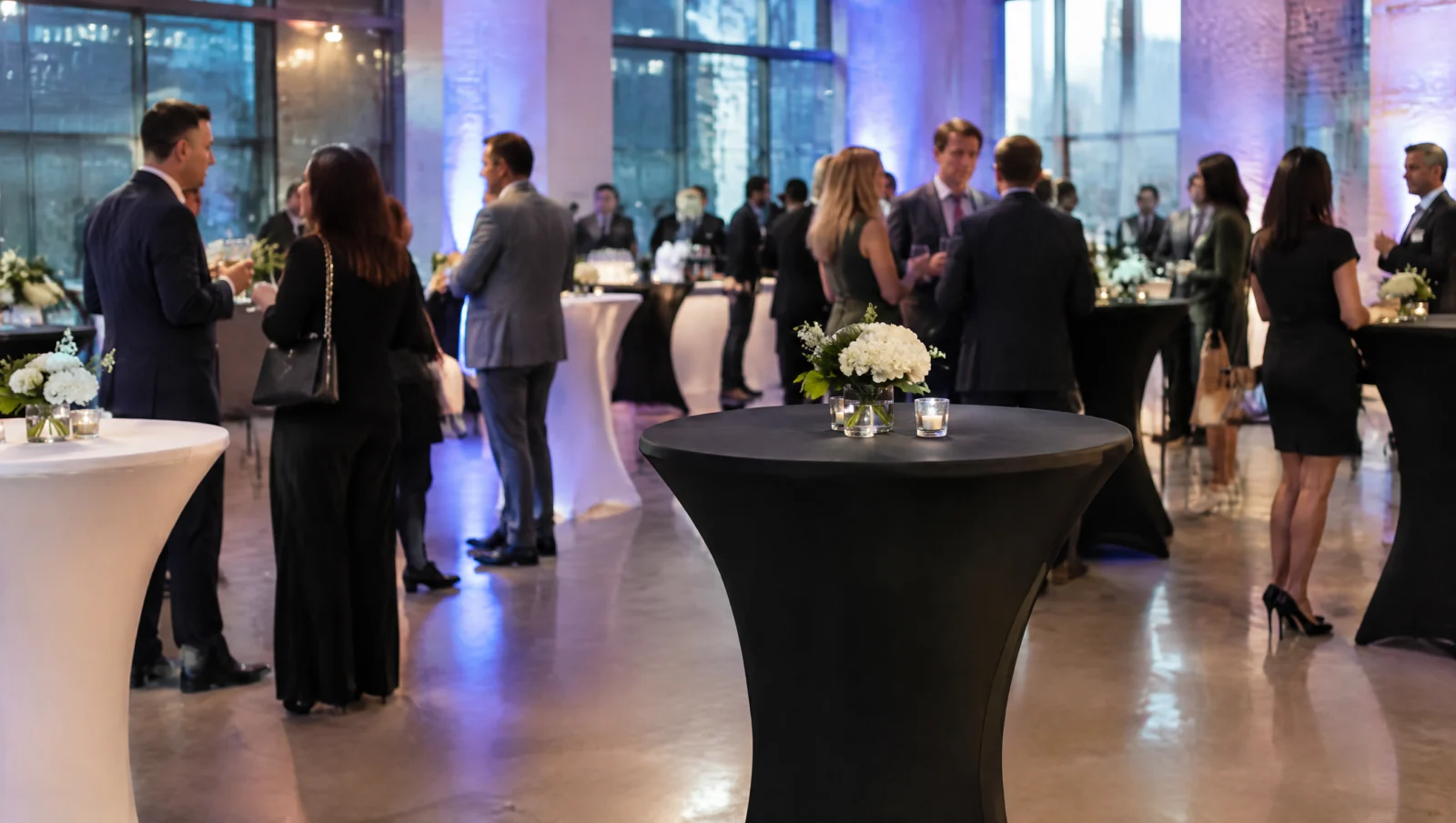 Spandex cocktail table covers in black and white at a corporate event