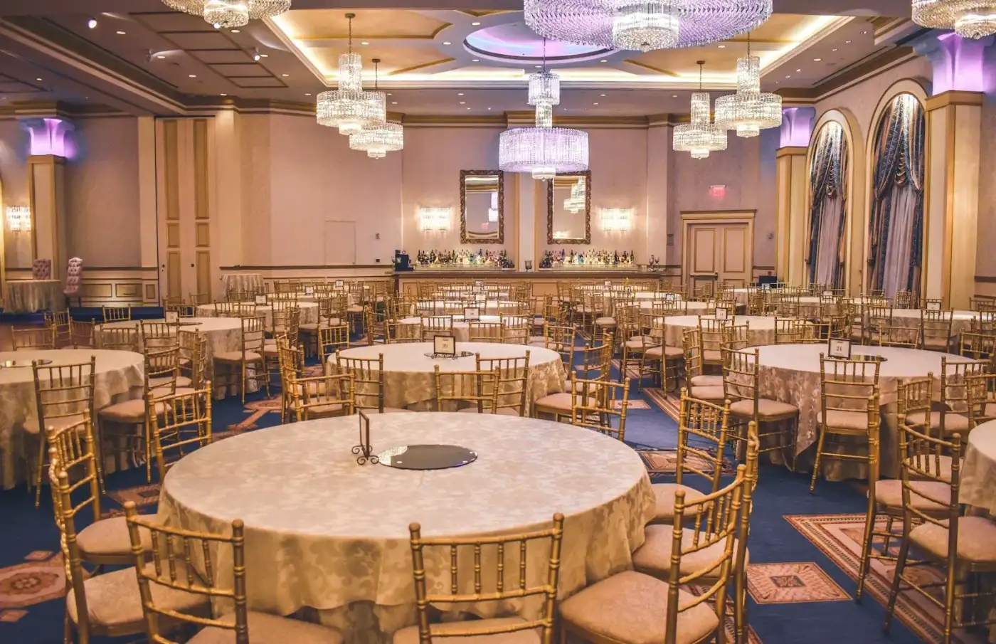 Venue capacity calculator guide: banquet hall with round tables and soft lighting set for an event